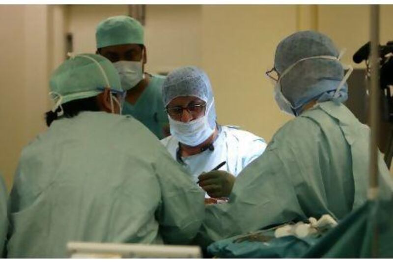Kneeling in worship puts a strain on standard knee implants. Above, Dr Deepak Bhatia performs knee surgery on Shadmani Perveen at Al Zahra Hospital in Sharjah, providing her with an implant suited to her body and needs.