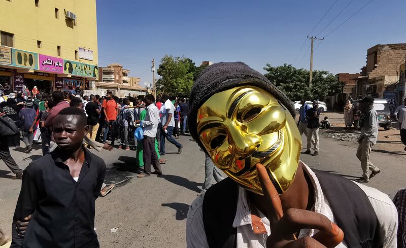 A mask-clad Sudanese protester attends a demonstration. AFP