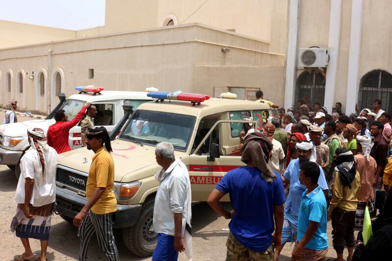 People gather as ambulances transport casualties of missile strikes on Al Anad airbase to the Ibn Khaldun hospital in the government-held southern province of Lahij. AFP