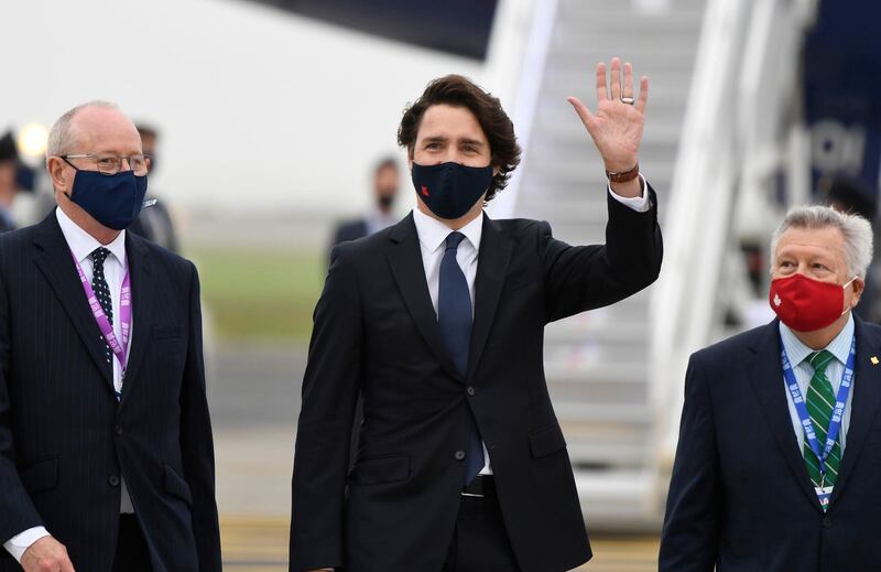 Canadian Prime Minister Justin Trudeau waves as he arrives for the G7 summit in Cornwall. Getty