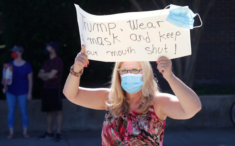 Ruth Schor holds a sign during a protest outside where President Donald Trump was holding a meeting during a fund raising trip in Dallas. AP Photo