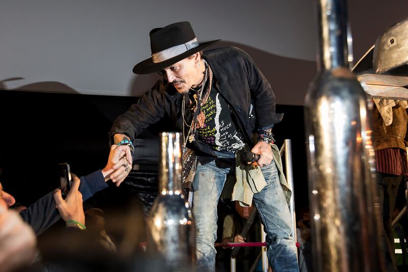 Actor Johnny Depp greets fans at the Glastonbury music festival at Worthy Farm, in Somerset, England. Grant Pollard / Invision / AP