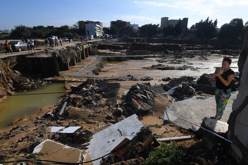 The Tunisian coastal town of Nabeul shows people gathering at the site of a collapsed bridge following deadly flash flooding. AFP