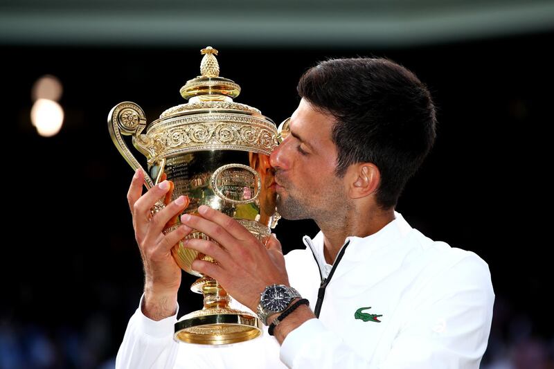 LONDON, ENGLAND - JULY 14:  Novak Djokovic of Serbia kisses the trophy after winning his Men's Singles final against Roger Federer of Switzerland during Day thirteen of The Championships - Wimbledon 2019 at All England Lawn Tennis and Croquet Club on July 14, 2019 in London, England. (Photo by Clive Brunskill/Getty Images)