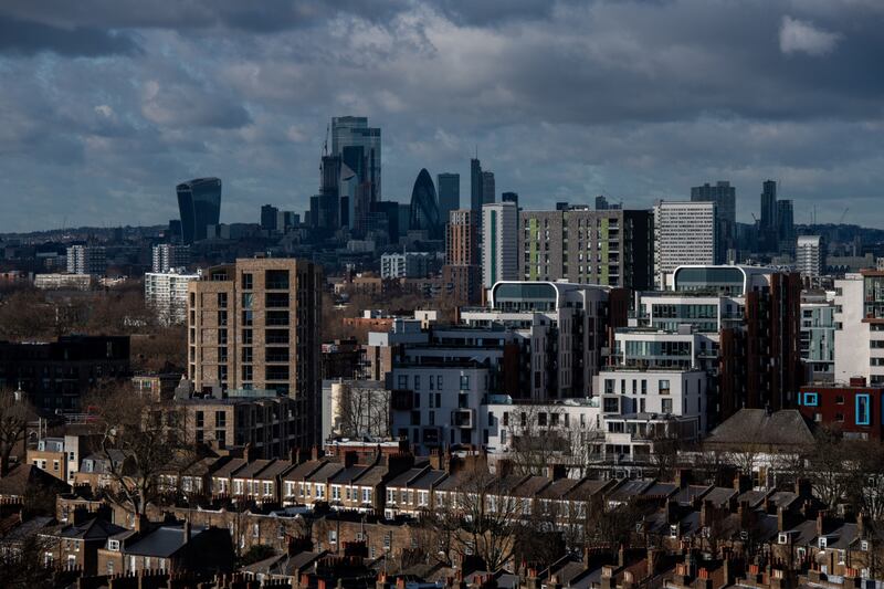Skyscrapers in the City of London's square mile financial district on the skyline beyond residential property in London. Britain's annual rate of growth remained steady in at 9.7 per cent, with the average home hitting a record high of £276,759 at the start of 2022. Bloomberg