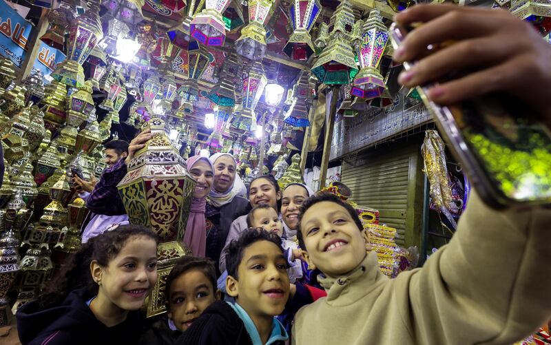 An Egyptian family out shopping for traditional decorative Ramadan lanterns, called Fanous, in the Sayyidah Zaynab district in Cairo. Reuters