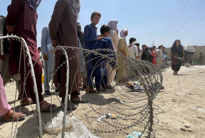 People queue outside Kabul airport as they try to leave Afghanistan following the Taliban takeover. Reuters