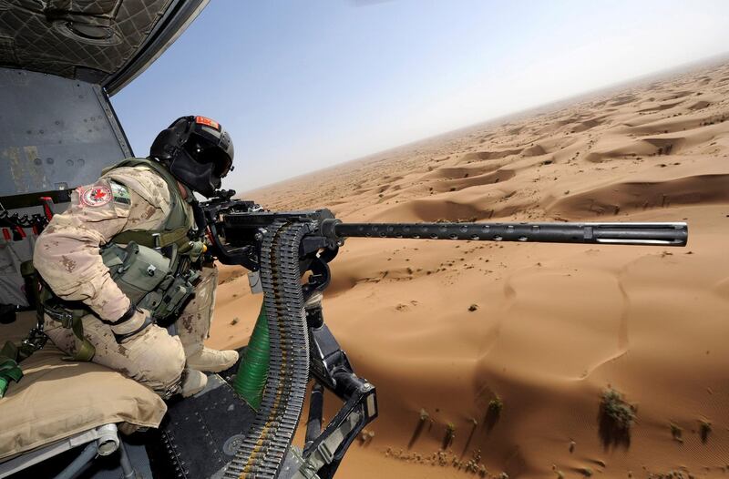 Door gunner sergeant Chad Zopf leans out of a CH-146 Griffon helicopter during a training exercise in Kandahar district, Afghanistan June 18, 2011 in this handout photo obtained by Reuters on March 19, 2018. Sgt Matthew McGregor / Canada Department of National Defence / Handout via Reuters
