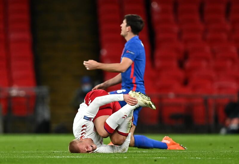 Denmark's Kasper Dolberg looks in pain after a challenge by England's Harry Maguire. PA