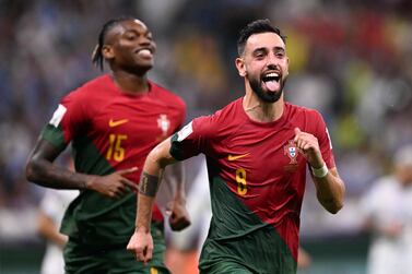 Portugal's midfielder #08 Bruno Fernandes (R) celebrates scoring his team's second goal during the Qatar 2022 World Cup Group H football match between Portugal and Uruguay at the Lusail Stadium in Lusail, north of Doha on November 28, 2022.  (Photo by Kirill KUDRYAVTSEV  /  AFP)