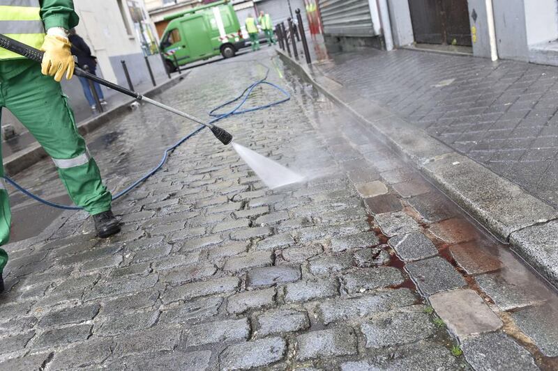 A street cleaner arrives to clean blood from the pavement near a patisserie at the Rue de Charonne in Paris on November 14, 2015, following the series of coordinated attacks. Loic Venace/AFP Photo