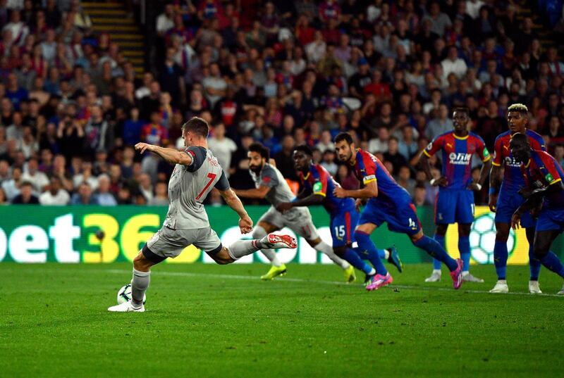 Liverpool midfielder James Milner converts the resulting penalty. EPA