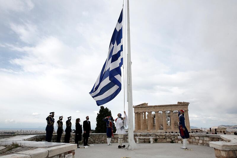 Greek Presidential Guards hoist the Greek flag in front of the Parthenon temple at Acropolis hill. EPA