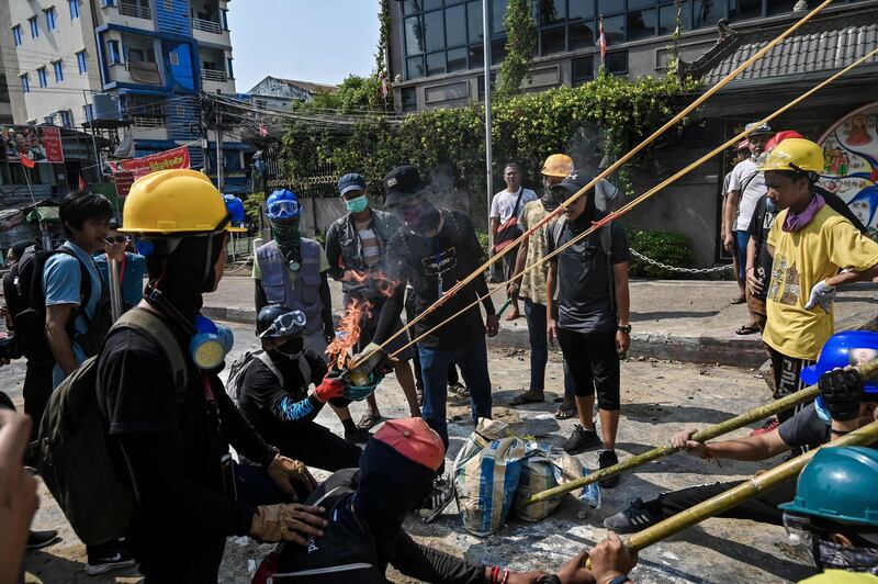 Protesters test a makeshift sling shot before facing off against police, during a crackdown by security forces on demonstrations against the military coup, in Yangon, Myanmar. AFP