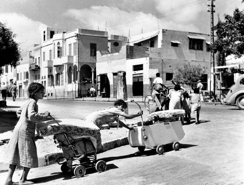 Arab families leave the Mediterranean coastal town of Jaffa in 1948, barefoot and pushing their belongings in prams and carts. UN