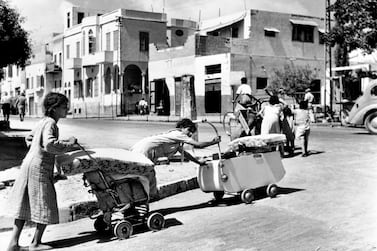 1948, Last days in Jaffa, 1948. Barefoot and pushing their belongings in prams and carts, Arab families leave the Mediterranean costal town of Jaffa. Credit: UN Photo