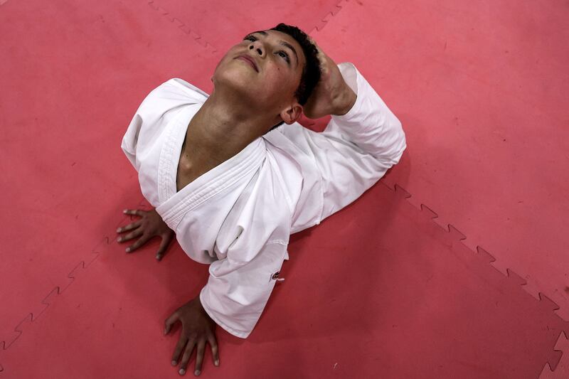 A karate student practises yoga.