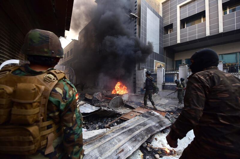 Iraqi anti-riot police forces clash with anti-government protesters at the Al Rasheed street in central Baghdad.  EPA