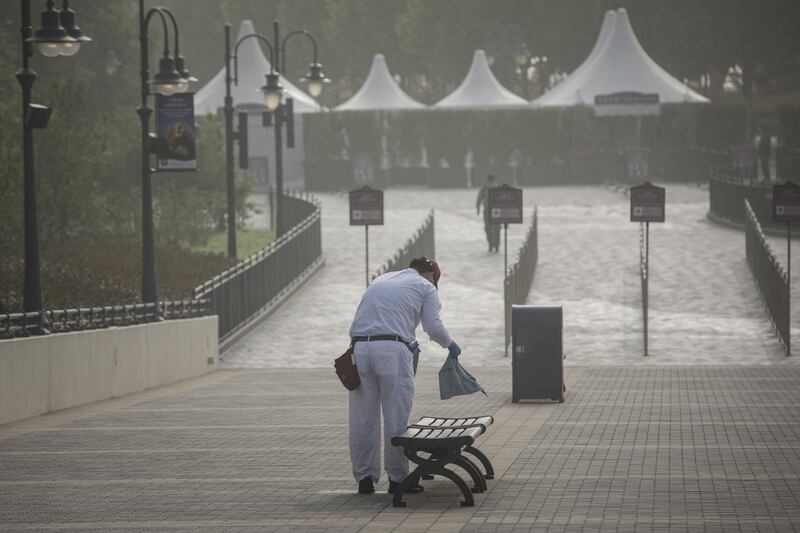An employee cleans a bench ahead of the reopening of the Shanghai Disneyland following its shutdown because of the coronavirus in Shanghai, China, on Monday, May 11, 2020. Bloomberg