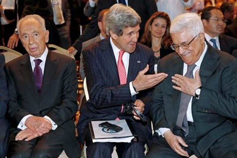 US Secretary of State John Kerry speaks with Palestinian President Mahmoud Abbas, right, as he sits next to Israeli president Shimon Peres at the World Economic Forum on the Middle East and North Africa at the King Hussein Convention Centre, at the Dead Sea May 26, 2013.  (AP Photo/Jim Young, Pool) *** Local Caption ***  Mideast Kerry.JPEG-06723.jpg