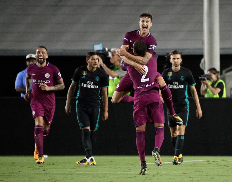 Manchester City's John Stones, top, celebrates his goal with Kyle Walker. Jae C Hong / AP Photo