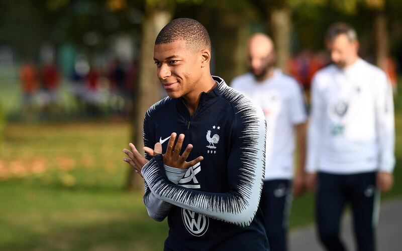 France's forward Kylian Mbappe arrives for a training session during a training session in Clairefontaine-en-Yvelines on October 13, 2018, as part of the team's preparation for the upcoming Nations League football match. / AFP / FRANCK FIFE
