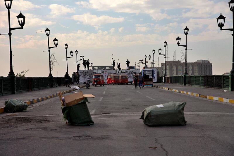 Protesters stage a sit-in on barriers at the Ahrar bridge. AP Photo