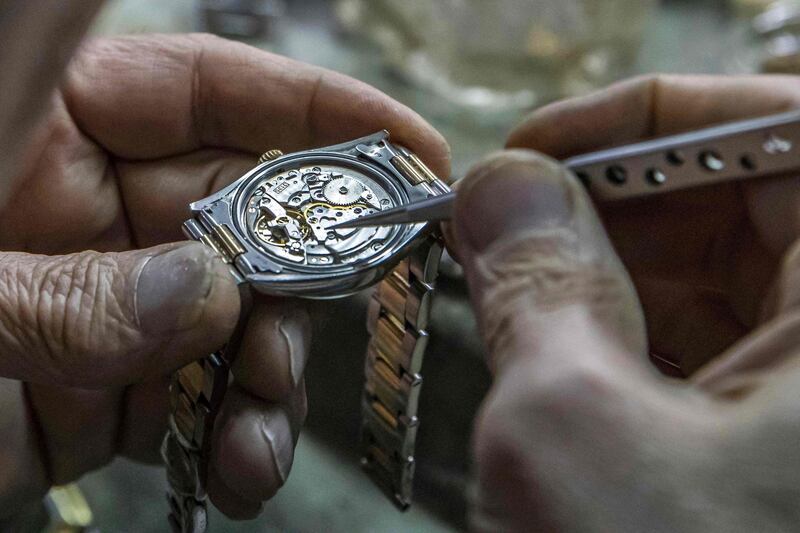 Samy Taha, 63, repairs a watch at the Francis Papazian in the central Attaba district of Cairo. AFP