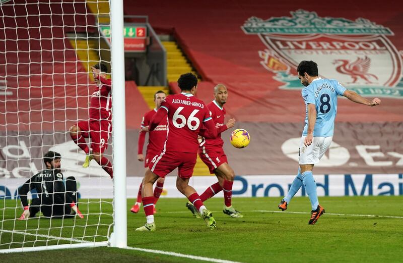 LIVERPOOL, ENGLAND - FEBRUARY 07: Ilkay Guendogan of Manchester City scores their team's second goal past Trent Alexander-Arnold of Liverpool during the Premier League match between Liverpool and Manchester City at Anfield on February 07, 2021 in Liverpool, England. Sporting stadiums around the UK remain under strict restrictions due to the Coronavirus Pandemic as Government social distancing laws prohibit fans inside venues resulting in games being played behind closed doors (Photo by Jon Super - Pool/Getty Images)