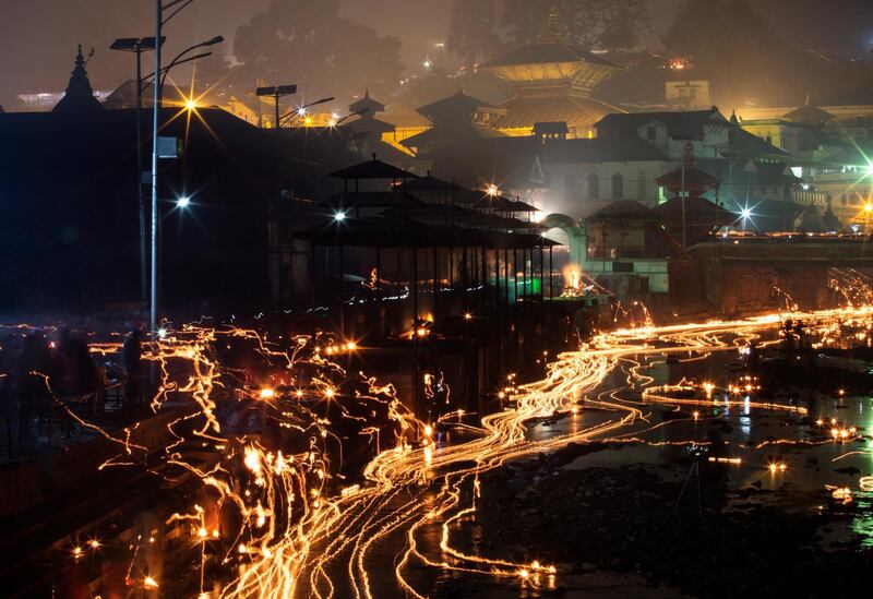 The oil lamps are released in memory of deceased family members during the Balachaturdashi festival at Pashupati temple in Kathmandu. EPA