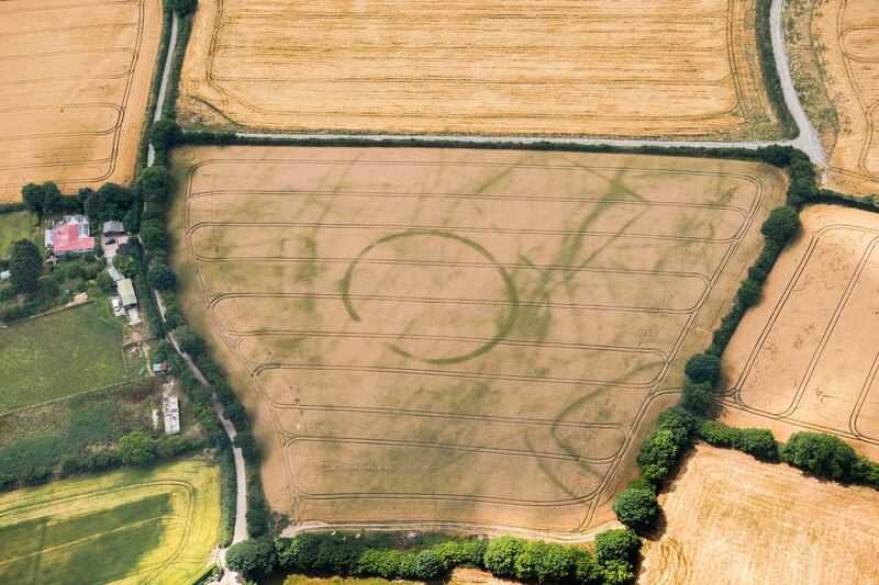 Iron Age Round, St Ive, Cornwall. The circular feature visible in the centre of this  photograph is probably a Round. Rounds were widespread in Cornwall in the Iron Age. These settlements consist of a circular bank and outer ditch with a single entrance and usually contained round houses positioned close to the edge of the outer ditch. Photo: Damian Grady. Copyright Historic England