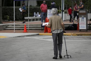 A voter walks to cast a ballot at a drop box at an early voting polling location for the 2020 Presidential election in Miami, Florida. Bloomberg