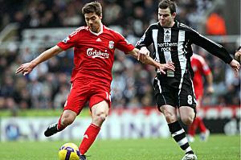 Liverpool's Xabi Alonso, left, vies with Newcastle United's Danny Guthrie.