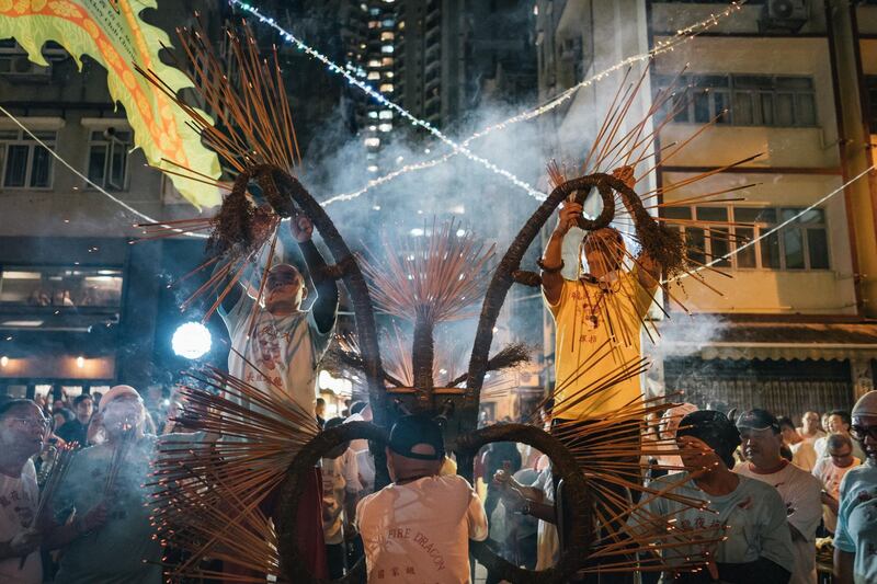 Members of the fire dragon dance team arrange joss sticks onto the dragon during the Tai Hang Fire Dragon Dance Festival.