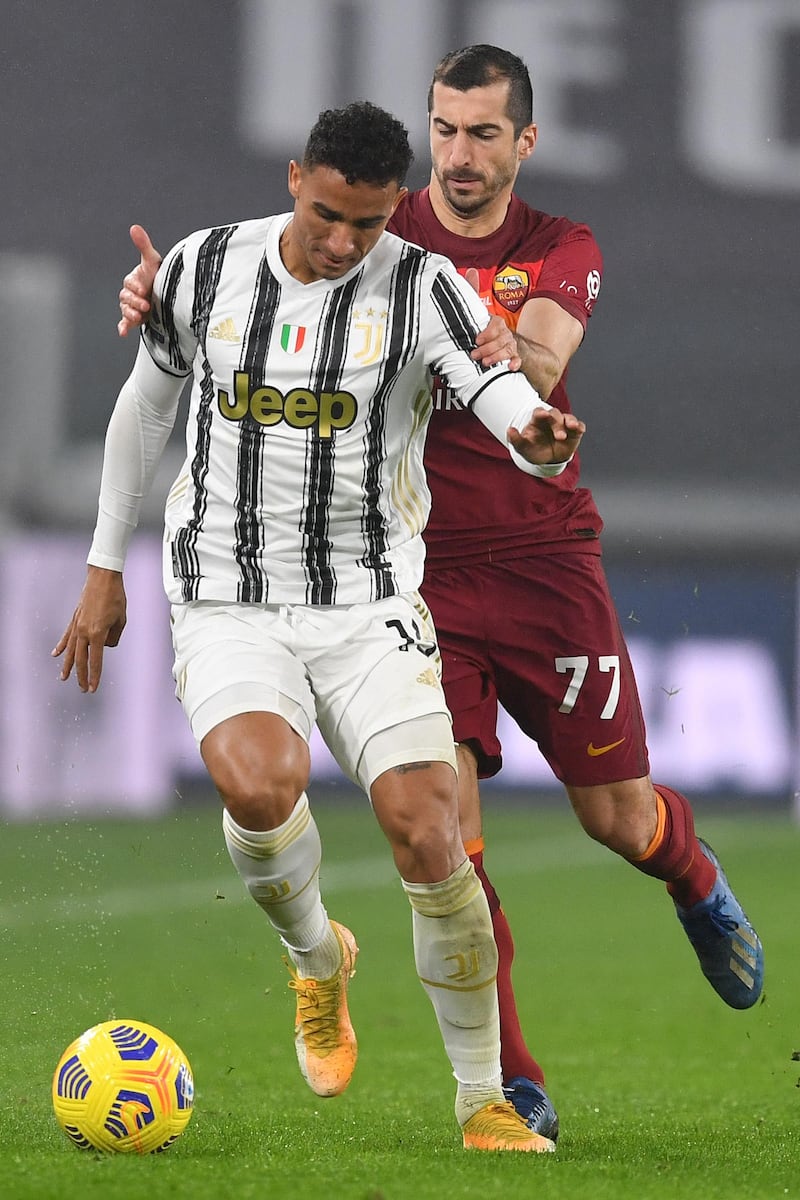 Juve's Danilo is challenged by Henrikh Mkhitaryan of Roma. Getty