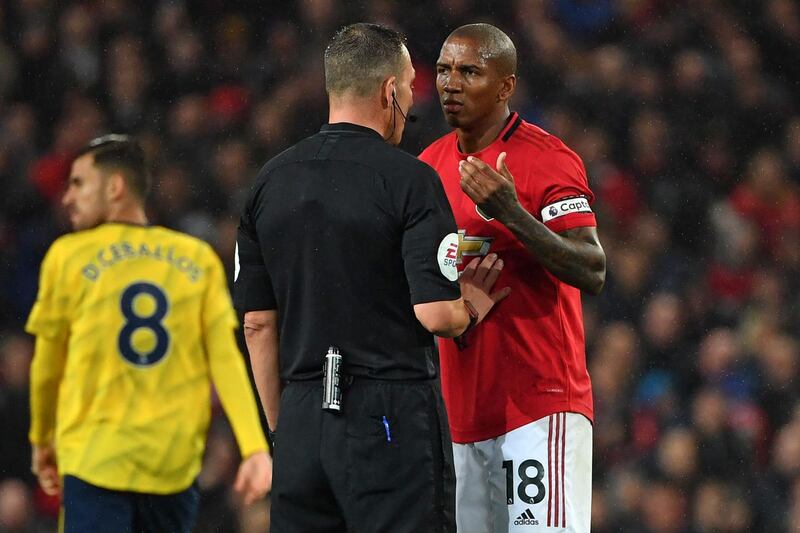 Manchester United's Ashley Young appeals to referee Kevin Friend after an offside goal from Arsenal striker Pierre-Emerick Aubameyang is overturned by VAR. AFP