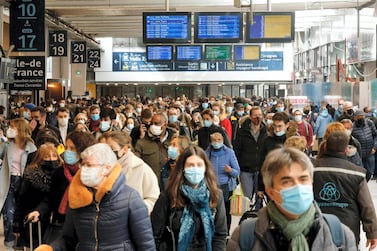 Parisians arrive to catch trains leaving from the Gare Montparnasse hours before a new lockdown in the French capital imposed to combat a surge in coronavirus infections. AFP