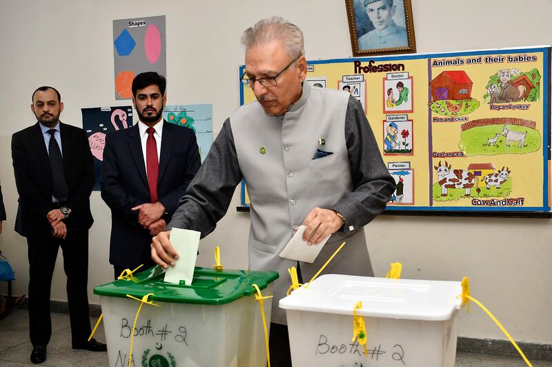 Pakistan's President Ariv Alvi casts his vote at a polling station in Karachi during parliamentary elections. AP