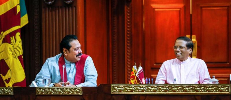 Sri Lanka's newly appointed Prime Minister  Mahinda Rajapaksa (L) smiles next to President Maithripala Sirisena during their party members' meeting in Colombo, Sri Lanka October 27, 2018. Sri Lanka's President's Office/Handout via REUTERS ATTENTION EDITORS - THIS IMAGE WAS PROVIDED BY A THIRD PARTY. NO RESALES. NO ARCHIVES