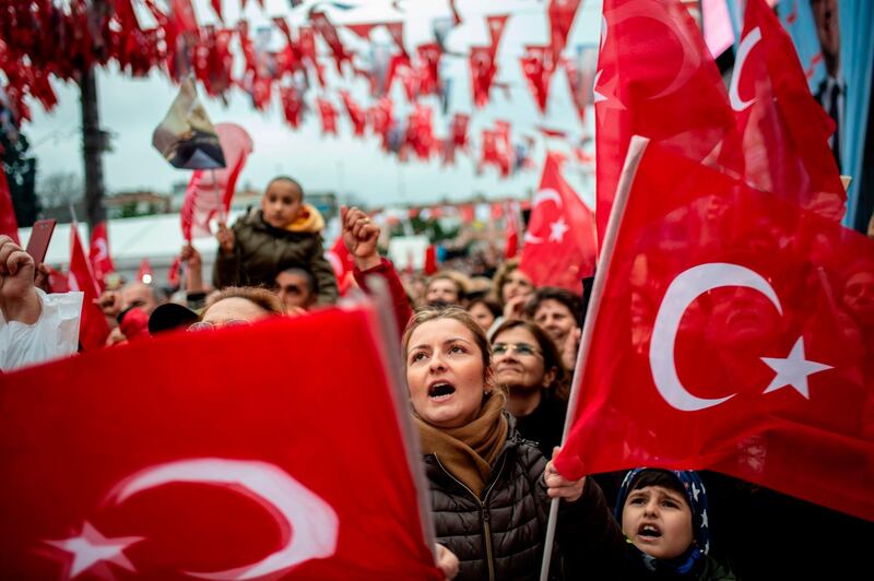 Supporters of the main opposition Republican People's Party's (CHP) mayoral candidate  wave Turkish national flags during a gathering in Istanbul.  AFP