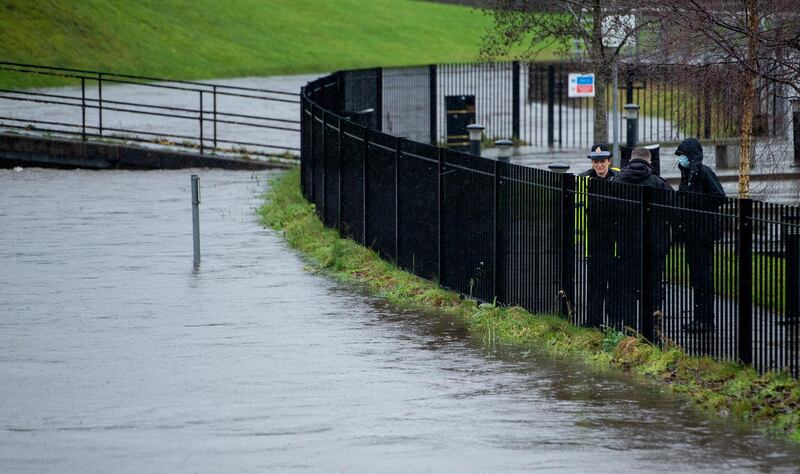 Police watch the rising level of the River Roch in Rochdale. EPA