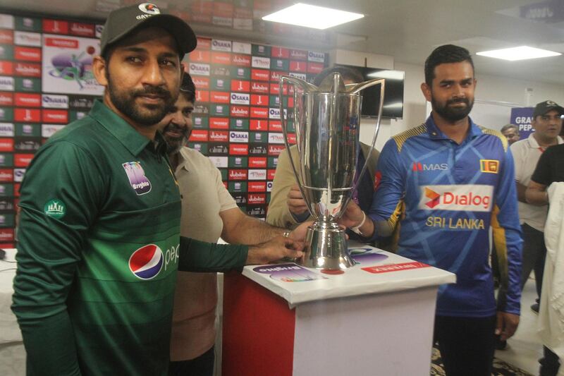Sri Lanka captain Lahiru Thirimanne, right, and his Pakistani rival Sarfaraz Ahmed stand with a trophy, in Karachi, Pakistan, Thursday, Sept. 26, 2019. Thirimanne wants the focus to move from security in Pakistan to the cricket itself when their three-match ODI series starts Friday. (AP Photo/Fareed Khan)