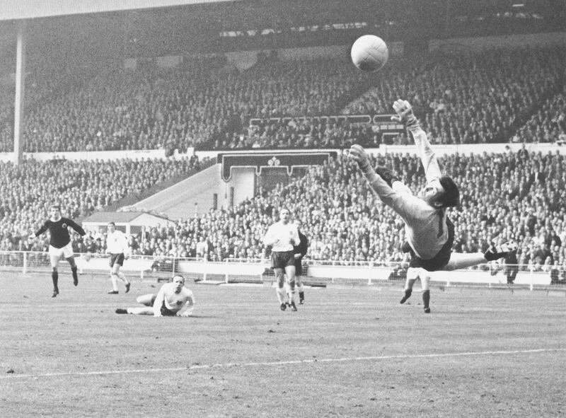 England goalkeeper Gordon Banks saves a shot from Denis Law during an England V Scotland match at Wembley, London, while Nobby Stiles looks on from the ground, 15th April 1967. Scotland won 2-3. (Photo by Douglas Miller/Keystone/Getty Images)