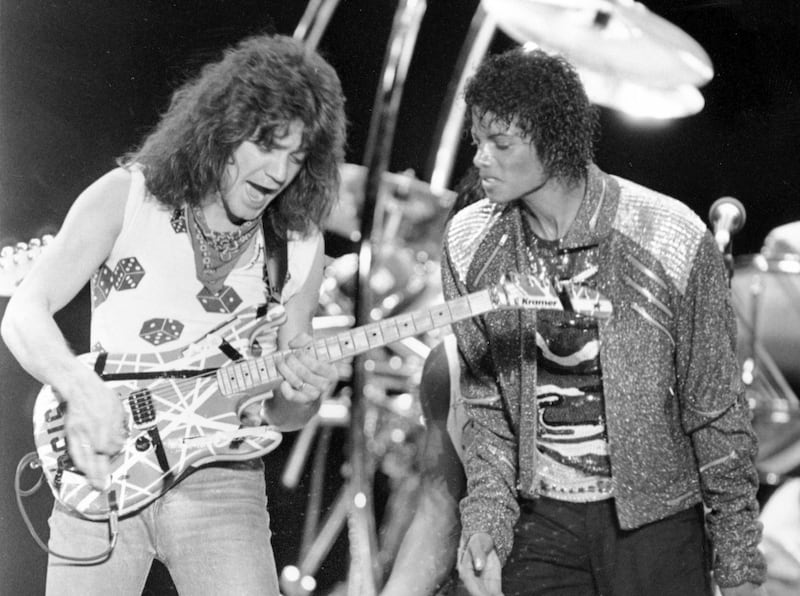 Van Halen guitarist Eddie Van Halen, left, performs 'Beat It' with Michael Jackson during Jackson's Victory Tour concert in Irving, Texas, on July 14, 1984. AP Photo