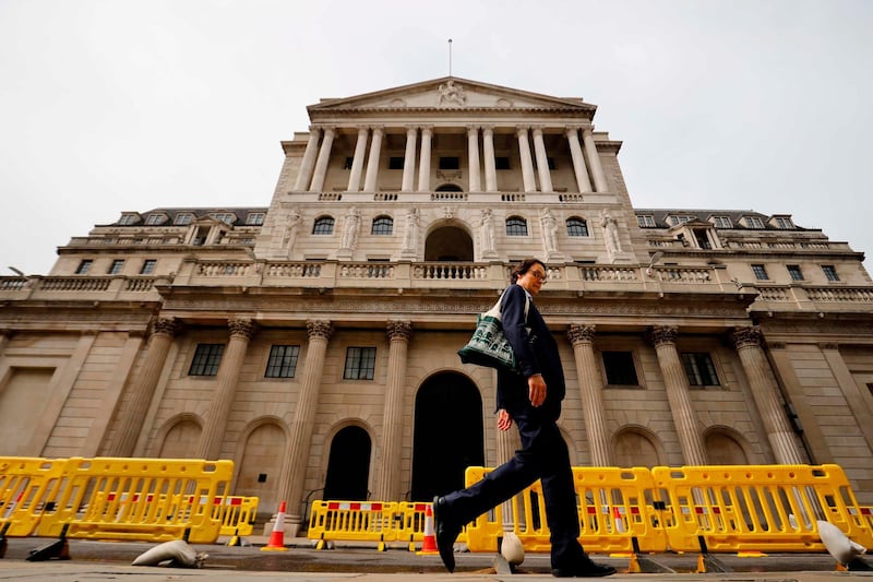 A pedestrian walks past the Bank of England in London on June 17, 2020.  The Bank of England, confronted by Britain's collapsing coronavirus-ravaged economy, will on June 18 reveal the outcome of its latest monetary policy meeting with analysts predicting more stimulus. The British central bank has been at the forefront of economic fire-fighting over this year's deadly COVID-19 emergency -- and could expand its quantitative easing (QE) stimulus in an attempt to kickstart growth. / AFP / Tolga Akmen
