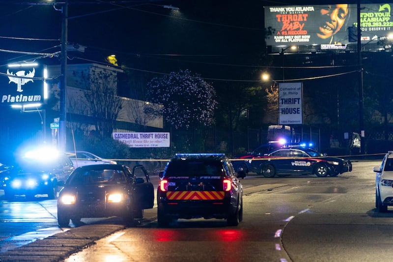 Atlanta Police vehicules are seen outside a massage parlor where a person was shot and killed in Atlanta, Georgia. Eight people were killed in shootings at three different spas in the US state of Georgia on March 16 and a 21-year-old male suspect was in custody, police and local media reported, though it was unclear if the attacks were related. AFP