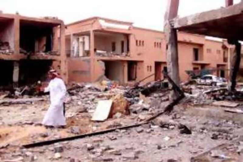 A Saudi security man walks in front of a damaged building after a suicide attack on a compound used by expatriates in Riyadh May 13, 2003. Suicide bombers in the Saudi  capital killed some 91 people, the U.S. vice president said on Tuesday, making the attack on expatriate housing compounds one of the biggest suspected al Qaeda strikes on Western targets. FR05070027 REUTERS/ STR