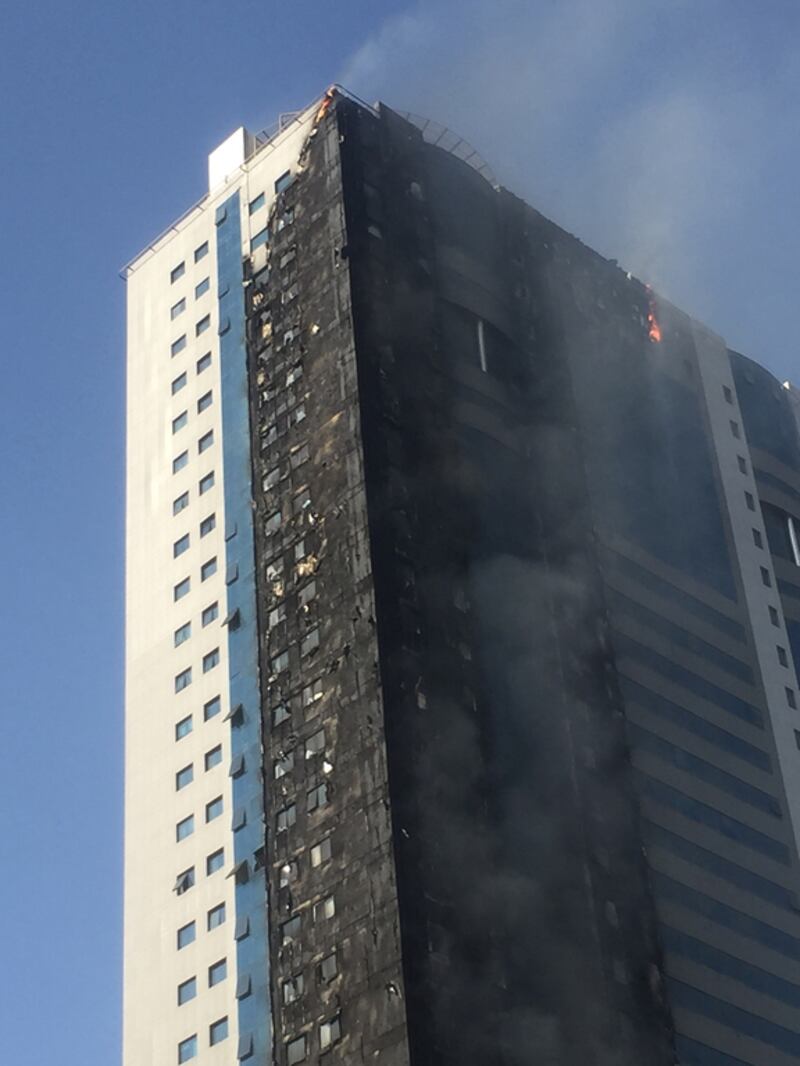 Plumes of black smoke could be seen pouring from the Abdul Naser building in King Faisal Road, Sharjah, from miles around. Thaer Zriqat/The National