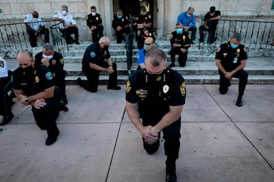 -- AFP PICTURES OF THE YEAR 2020 --

Police officers kneel during a rally in Coral Gables, Florida on May 30, 2020 in response to the recent death of George Floyd, an unarmed black man who died while being arrested and pinned to the ground by a Minneapolis police officer. Clashes broke out and major cities imposed curfews as America began another night of unrest Saturday with angry demonstrators ignoring warnings from President Donald Trump that his government would stop violent protests over police brutality "cold." - 
 / AFP / Eva Marie UZCATEGUI
