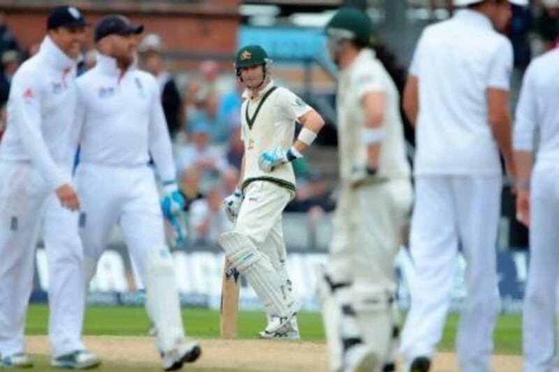 Michael Clarke, centre, was an unhappy man at the end of the fourth day's play at Old Trafford. Andrew Yates / AFP
